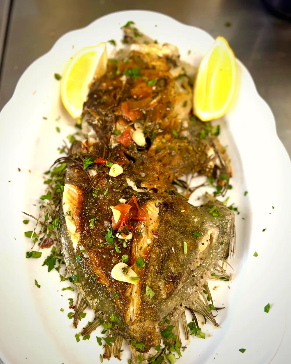 Ganzer gegrillter Fisch mit Zitrone und Kräutern
